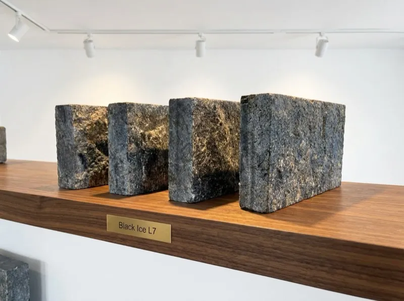 Black Ice L7 Labradorite pavers displayed in showroom with gallery lighting