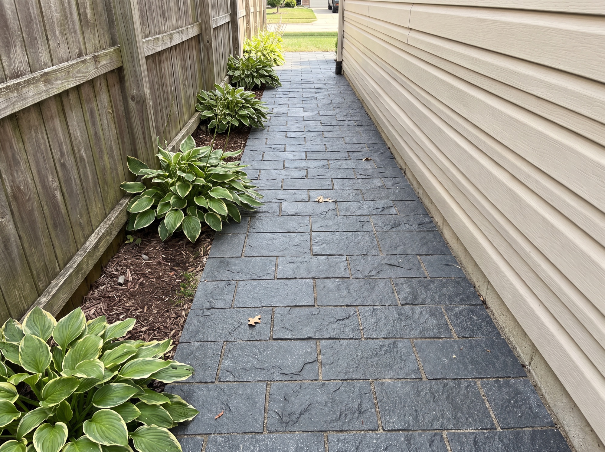 Narrow side yard path in dark splitface granite
