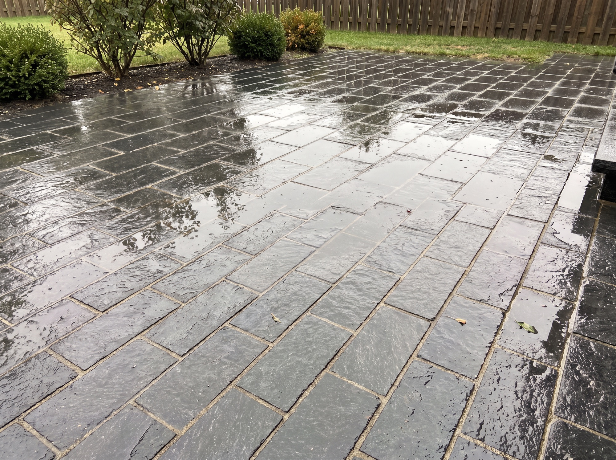 Dark splitface granite patio wet after rain